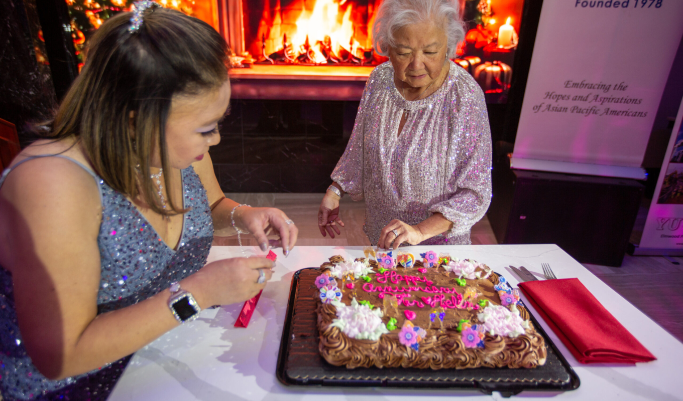 Gloria & Alyson looking at Ray’s B’day Cake 2024 HB