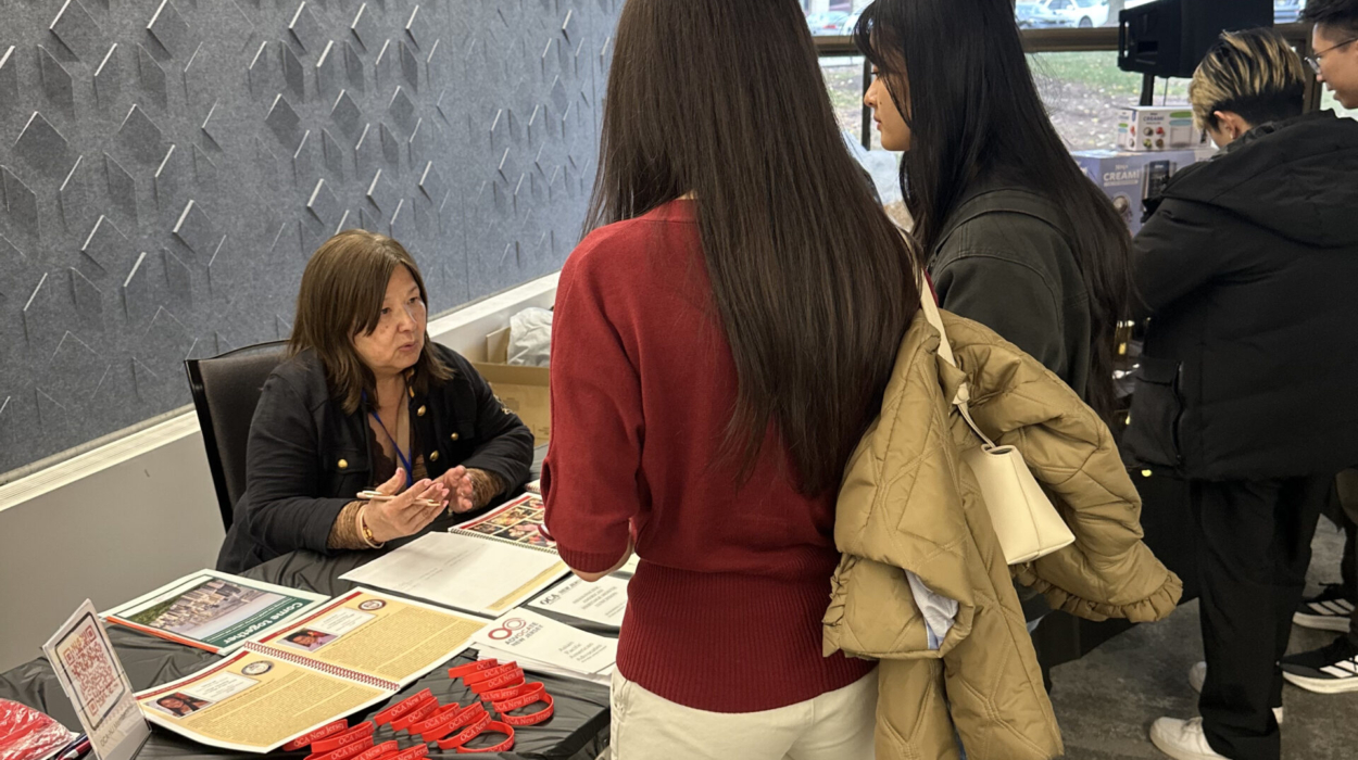 Jenny at OCA-NJ Booth talking to attendees – 2025 Temple St