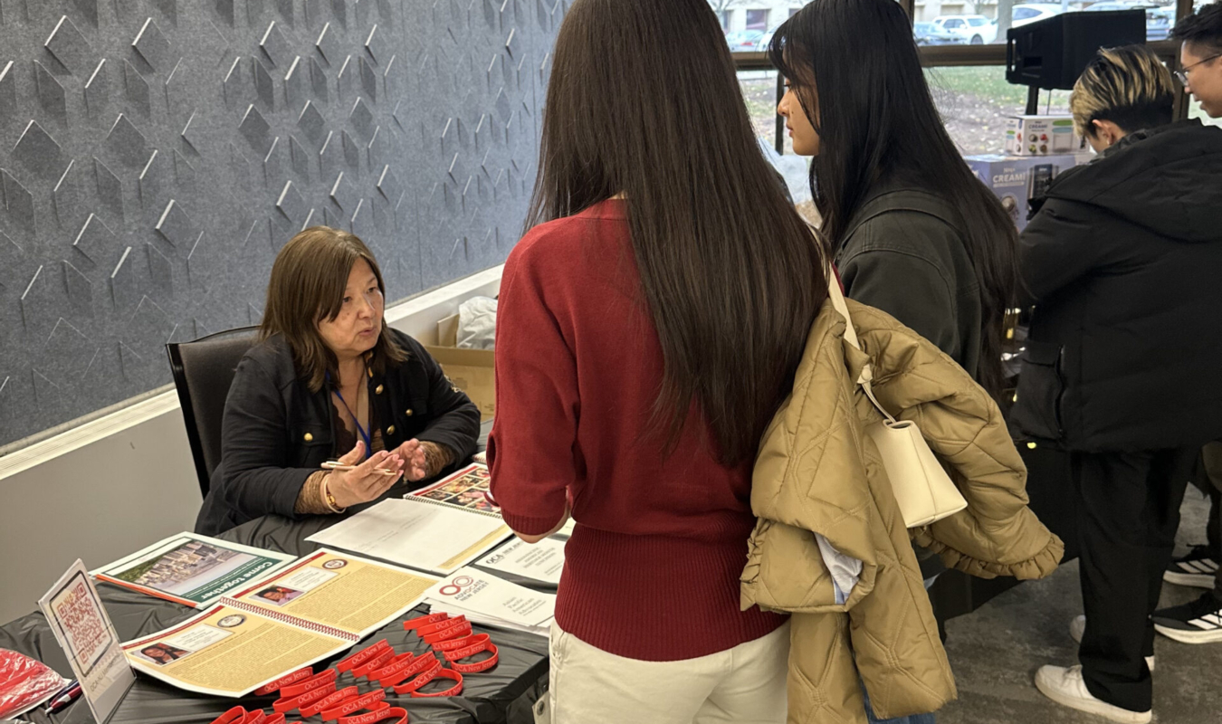 Jenny at OCA-NJ Booth talking to attendees – 2025 Temple St